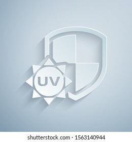 Paper cut UV protection icon isolated on grey background. Sun and shield. Ultra violet rays radiation. SPF sun sign. Paper art style. Vector Illustration