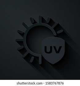 Paper cut UV protection icon isolated on black background. Sun and shield. Ultra violet rays radiation. SPF sun sign. Paper art style. Vector Illustration