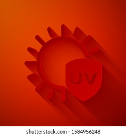Paper cut UV protection icon isolated on red background. Sun and shield. Ultra violet rays radiation. SPF sun sign. Paper art style. Vector Illustration