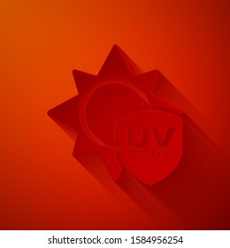 Paper cut UV protection icon isolated on red background. Sun and shield. Ultra violet rays radiation. SPF sun sign. Paper art style. Vector Illustration