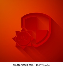 Paper cut UV protection icon isolated on red background. Sun and shield. Ultra violet rays radiation. SPF sun sign. Paper art style. Vector Illustration