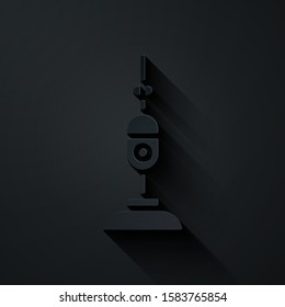Paper cut Vacuum cleaner icon isolated on black background. Paper art style. Vector Illustration