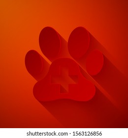 Paper cut Veterinary clinic symbol icon isolated on red background. Cross hospital sign. A stylized paw print dog or cat. Pet First Aid sign. Paper art style. Vector Illustration