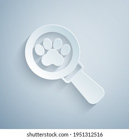 Paper cut Veterinary clinic symbol icon isolated on grey background. Cross hospital sign. Stylized paw print dog or cat. Pet First Aid sign. Paper art style. Vector