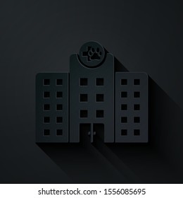 Paper cut Veterinary medicine hospital, clinic or pet shop for animals icon isolated on black background. Vet or veterinarian clinic. Paper art style. Vector Illustration