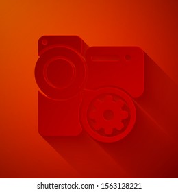 Paper cut Video camera and gear icon isolated on red background. Adjusting app, service concept, setting options, maintenance, repair, fixing. Paper art style. Vector Illustration