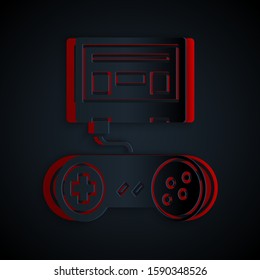 Paper cut Video game console with joystick icon isolated on black background. Paper art style. Vector Illustration