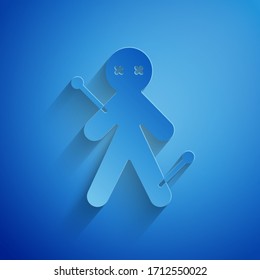 Paper cut Voodoo doll icon isolated on blue background. Paper art style. Vector Illustration