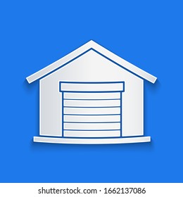Paper cut Warehouse icon isolated on blue background. Paper art style. Vector Illustration