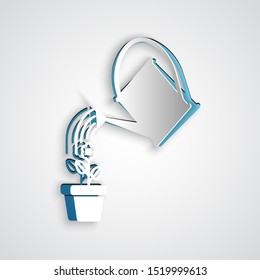 Paper cut Watering can sprays water drops above flower in pot icon isolated on grey background. Irrigation symbol. Paper art style. Vector Illustration