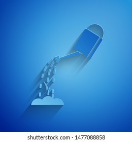Paper cut Watering can with water icon isolated on blue background. Watering a sprout. Irrigation symbol. Paper art style. Vector Illustration