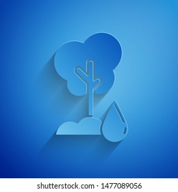 Paper cut Watering Tree icon isolated on blue background. Forest symbol. Irrigation symbol. Paper art style. Vector Illustration