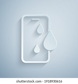 Paper cut Waterproof mobile phone icon isolated on grey background. Smartphone with drop of water. Paper art style. Vector.