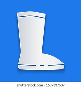 Paper cut Waterproof rubber boot icon isolated on blue background. Gumboots for rainy weather, fishing, gardening. Paper art style. Vector Illustration