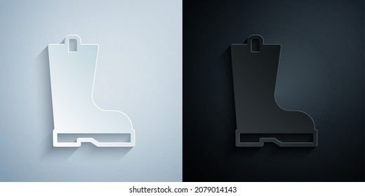 Paper cut Waterproof rubber boot icon isolated on grey and black background. Gumboots for rainy weather, fishing, gardening. Paper art style. Vector