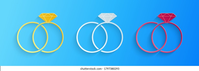 Paper cut Wedding rings icons isolated on blue background. Bride and groom jewelry sign. Marriage icon. Diamond ring icon. Paper art style. Vector.