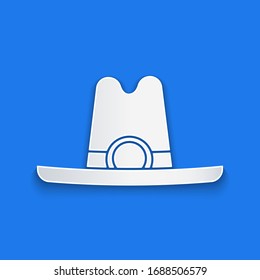 Paper cut Western cowboy hat icon isolated on blue background. Paper art style. Vector Illustration