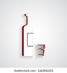 Paper cut Whiskey bottle and glass icon isolated on grey background. Paper art style. Vector Illustration