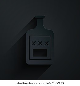 Paper cut Whiskey bottle icon isolated on black background. Paper art style. Vector Illustration