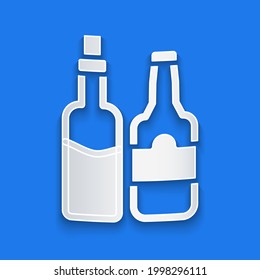 Paper cut Whiskey bottle icon isolated on blue background. Paper art style. Vector