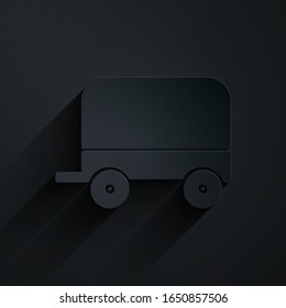 Paper cut Wild west covered wagon icon isolated on black background. Paper art style. Vector Illustration