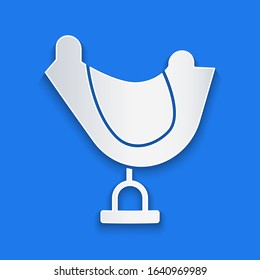 Paper cut Wild west saddle icon isolated on blue background. Paper art style. Vector Illustration