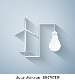 Paper cut Wind mill turbine generating power energy and light bulb icon on grey background. Alternative natural renewable energy production using wind mills. Paper art style. Vector Illustration