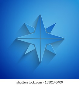 Paper cut Wind rose icon isolated on blue background. Compass icon for travel. Navigation design. Paper art style. Vector Illustration