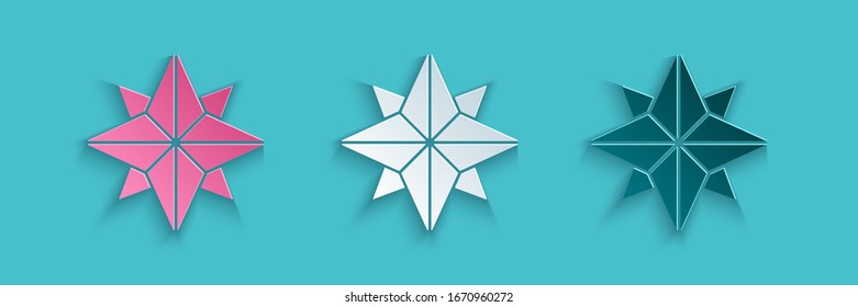 Paper cut Wind rose icon isolated on blue background. Compass icon for travel. Navigation design. Paper art style. Vector Illustration