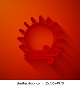 Paper cut Wind and sun icon isolated on red background. Windy weather. Paper art style. Vector Illustration