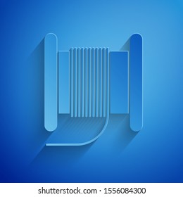 Paper cut Wire electric cable on a reel or drum icon isolated on blue background. Paper art style. Vector Illustration