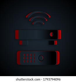 Paper cut Wireless multimedia and TV box receiver and player with remote controller icon isolated on black background. Paper art style. Vector