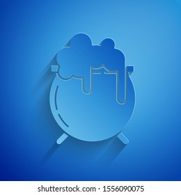 Paper cut Witch cauldron icon isolated on blue background. Happy Saint Patricks day. Paper art style. Vector Illustration