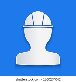 Paper cut Worker safety helmet icon isolated on blue background. Paper art style. Vector Illustration