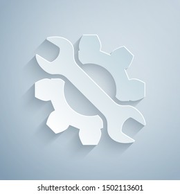 Paper cut Wrench and gear icon isolated on grey background. Adjusting, service, setting, maintenance, repair, fixing. Paper art style. Vector Illustration