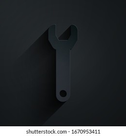 Paper cut Wrench spanner icon isolated on black background. Paper art style. Vector Illustration
