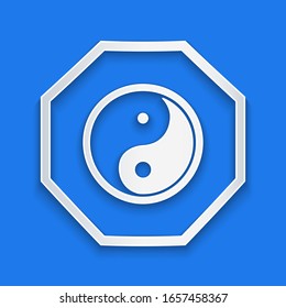 Paper cut Yin Yang symbol of harmony and balance icon isolated on blue background. Paper art style. Vector Illustration