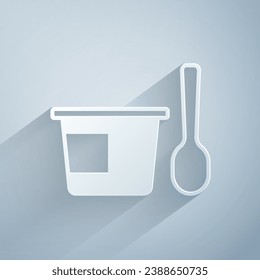 Paper cut Yogurt container with spoon icon isolated on grey background. Yogurt in plastic cup. Paper art style. Vector