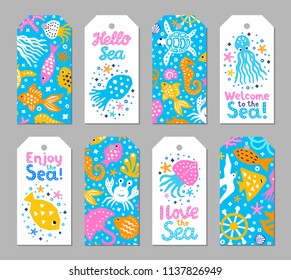 Paper cutout marine kids design element tags. Funny cartoon turtle, fish, octopus, shell, calmar, starfish, jellyfish doodle vector illustration. Lettering phrase I love, Enjoy, Hello, Welcome to sea