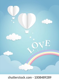 Paper cutting of two heart-shaped balloons on the sky over the rainbow