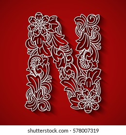 Paper cutting, white letter "N". Red background. Floral ornament, balinese traditional style.