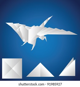 A paper dragon on a blue background. Origami