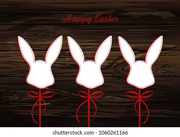 Paper easter bunny. Head of a rabbit on a stick with a bow and ribbon. Empty place for text or advertising. Greeting card or invitation for a holiday. Vector on wooden background.