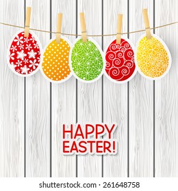 Paper Easter eggs on wooden background