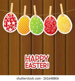 Paper Easter eggs on wooden background