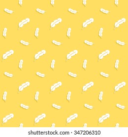 Paper feathers with a shadow on a yellow background, seamless pattern