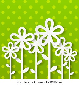 Paper flowers on green background