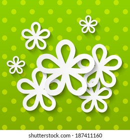 Paper flowers on green background