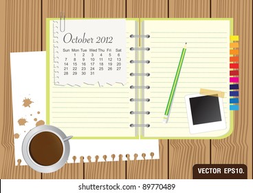 Paper and green Notebook With a cup of coffee and photo frame. on brown wood background. Calendar 2012 October Vector template for design work