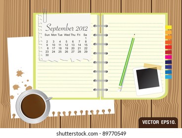 Paper and green Notebook With a cup of coffee and photo frame. on brown wood background. Calendar 2012 September Vector template for design work